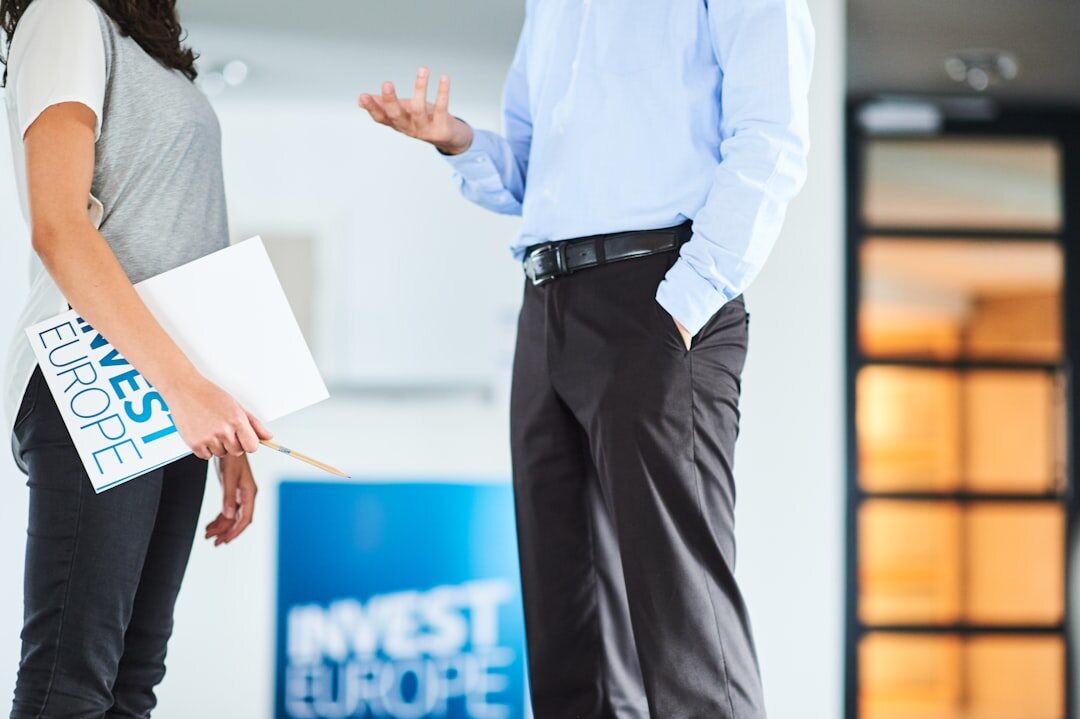 Diverse group of four European business professionals having a discussion in a modern office